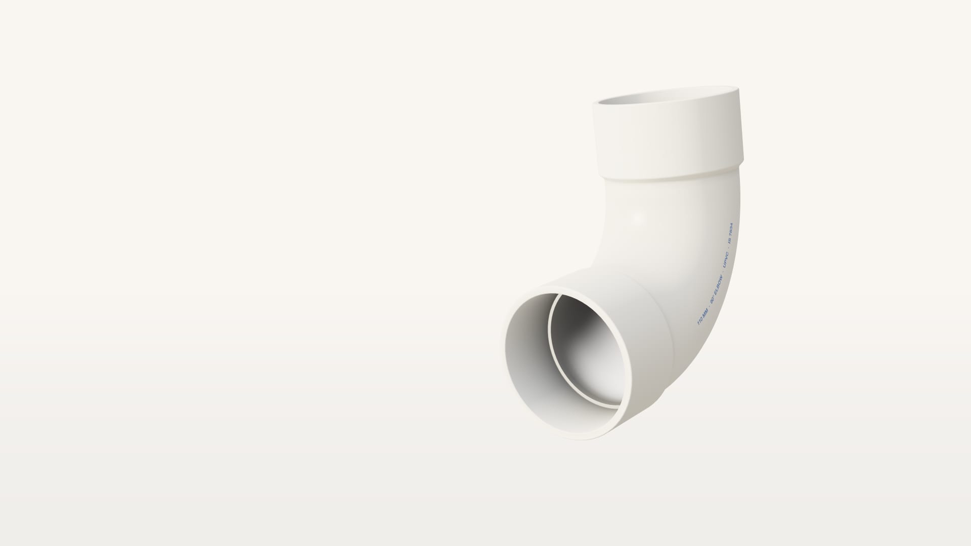 A white 110 mm uPVC 90° elbow with a socket at each end, one mouth turned to the light so the bore shows, raked by morning light.